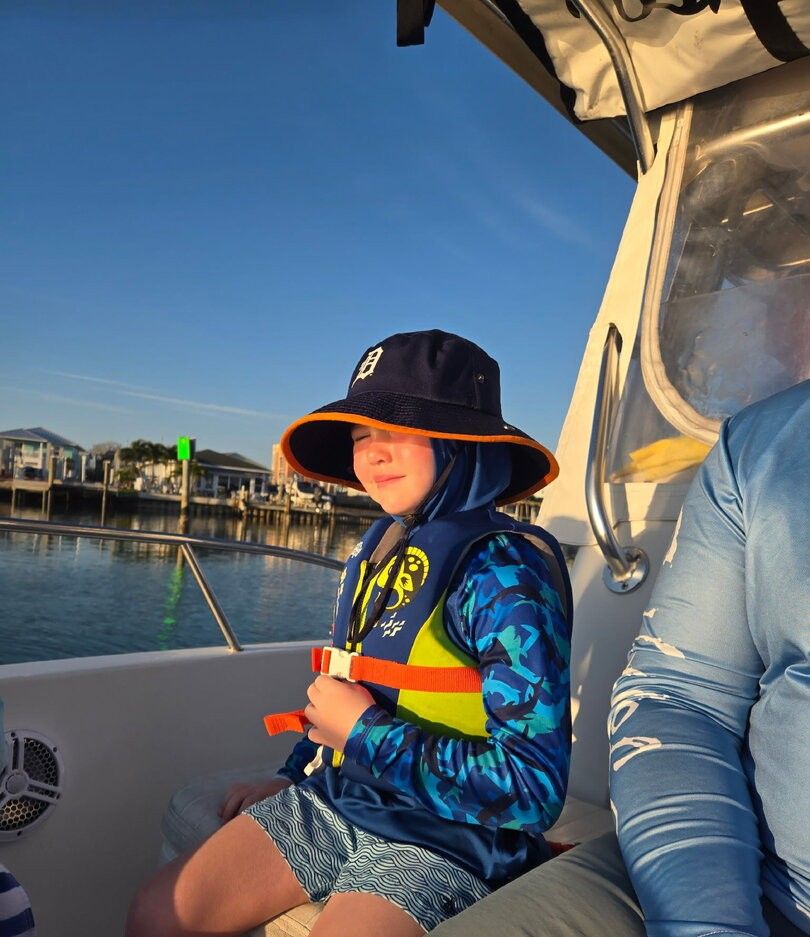 A person fishing at an unknown location