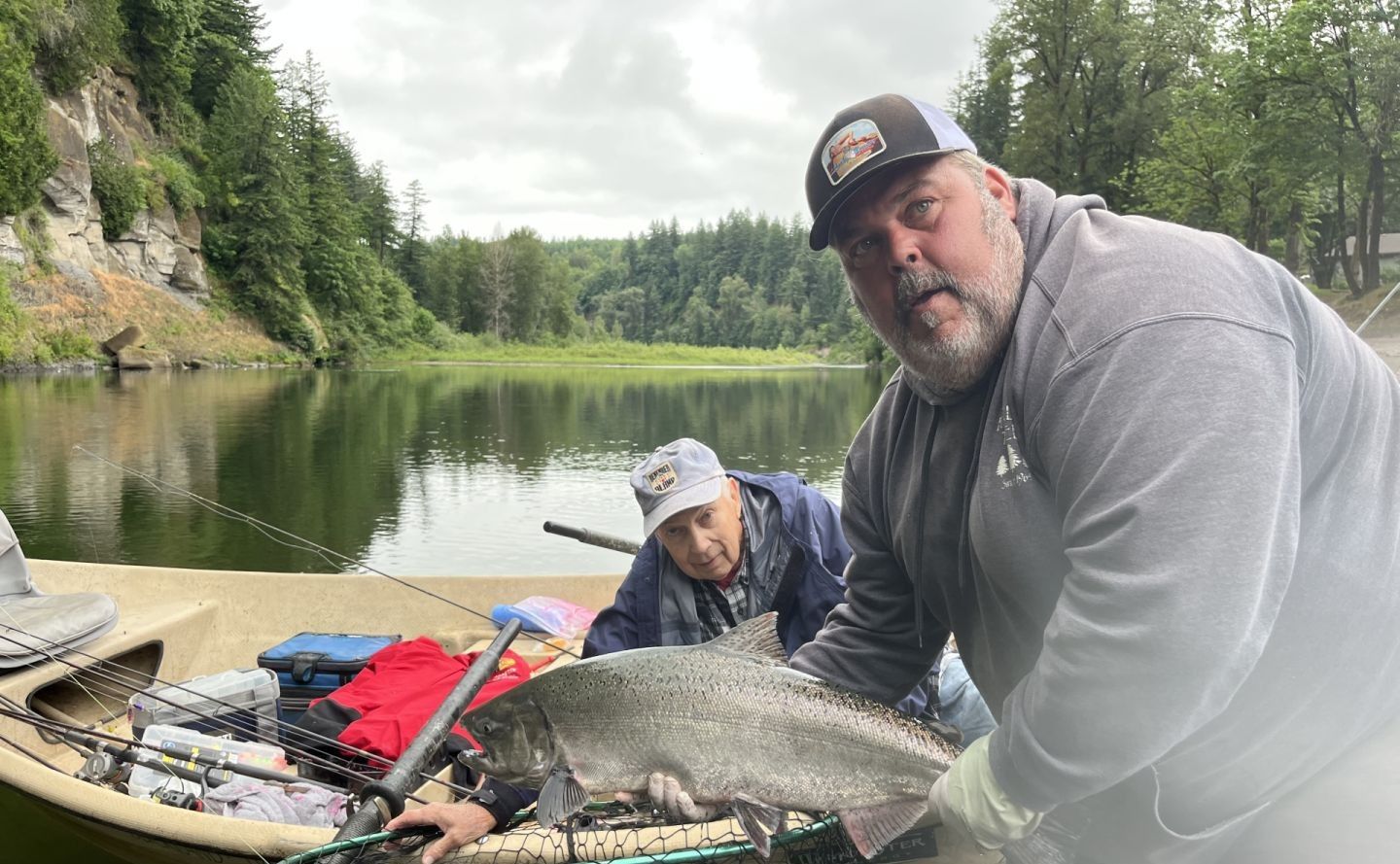 Two people enjoying a fishing trip at an unknown location
