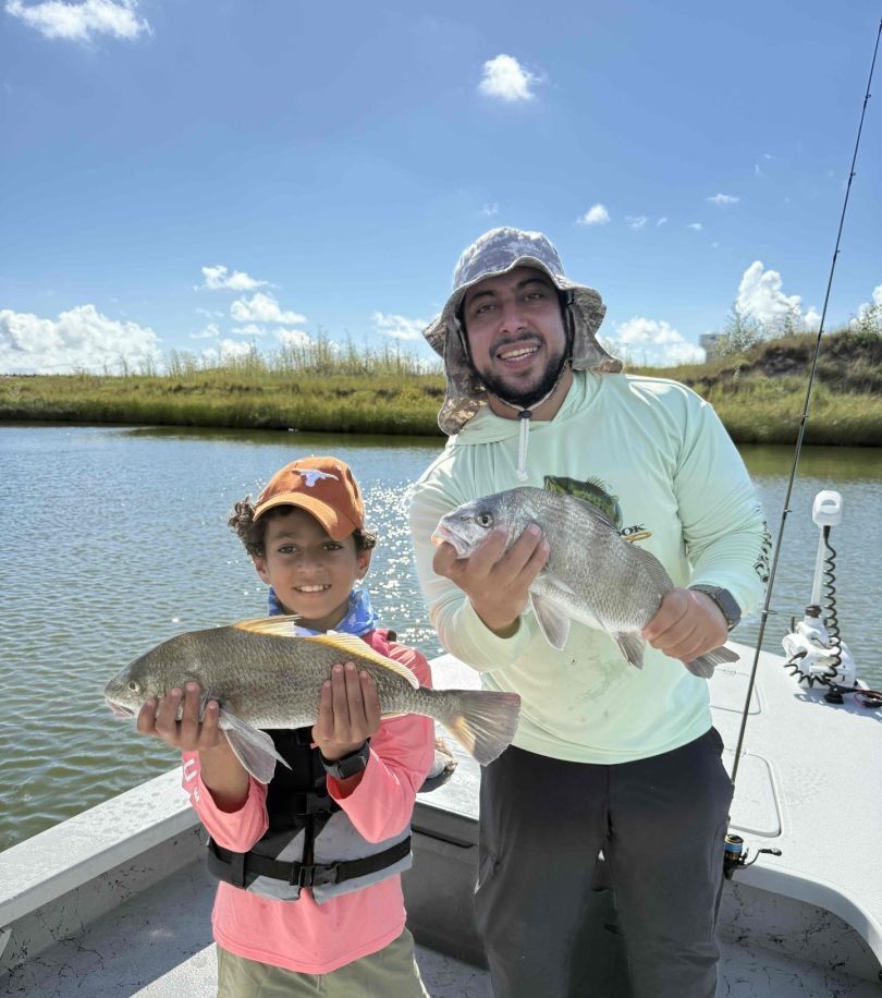 Two black drum fish being caught while fishing
