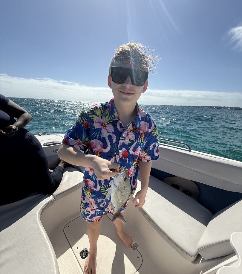 Small fish caught during fishing trip on boat in open water