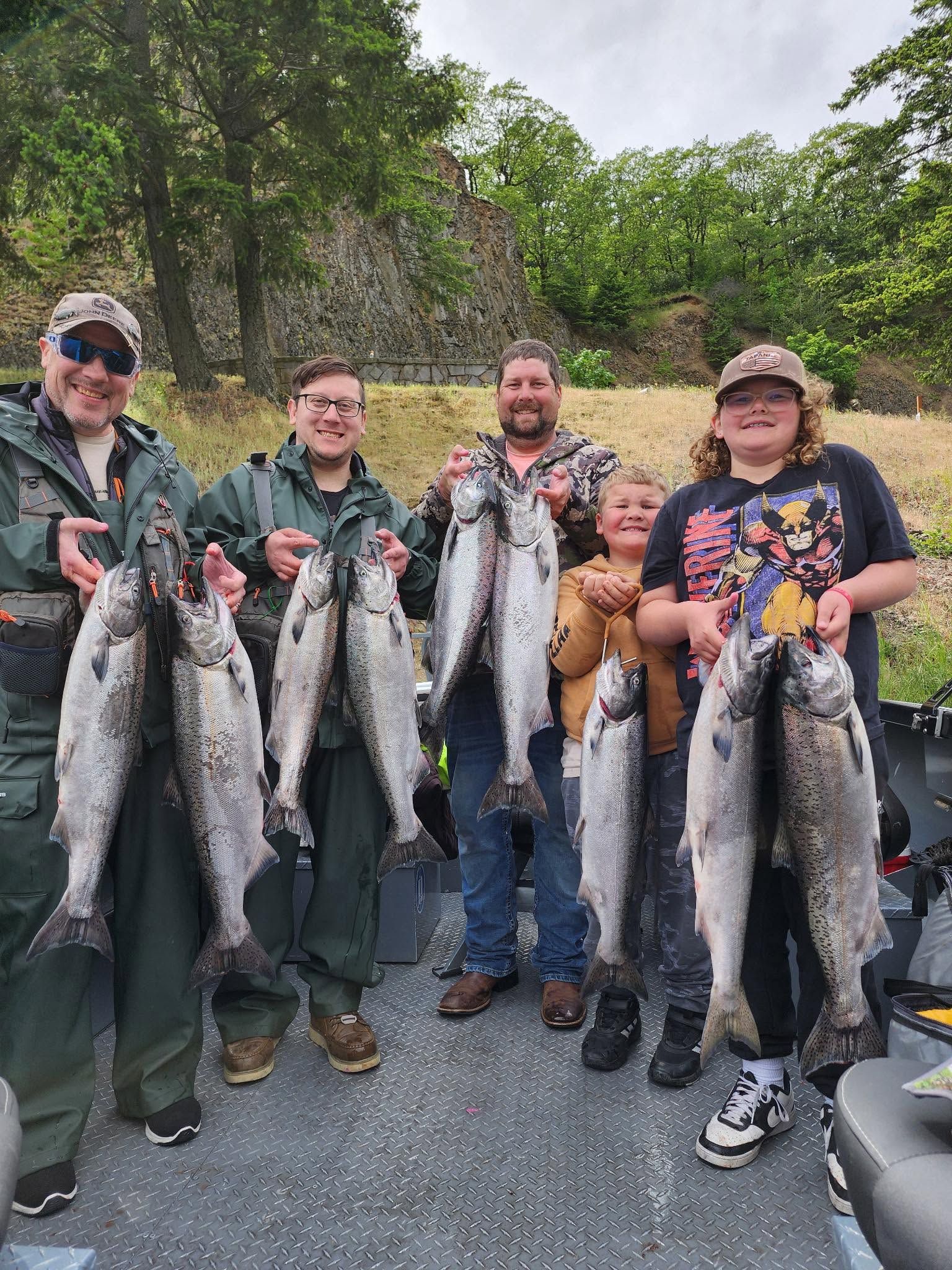 Successful fishing trip displaying nine Chinook and Coho salmon catch outdoors