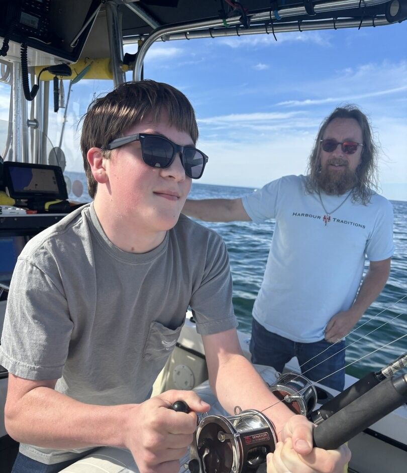 Fishing boat on open water with fishing rods and equipment ready for deep sea fishing