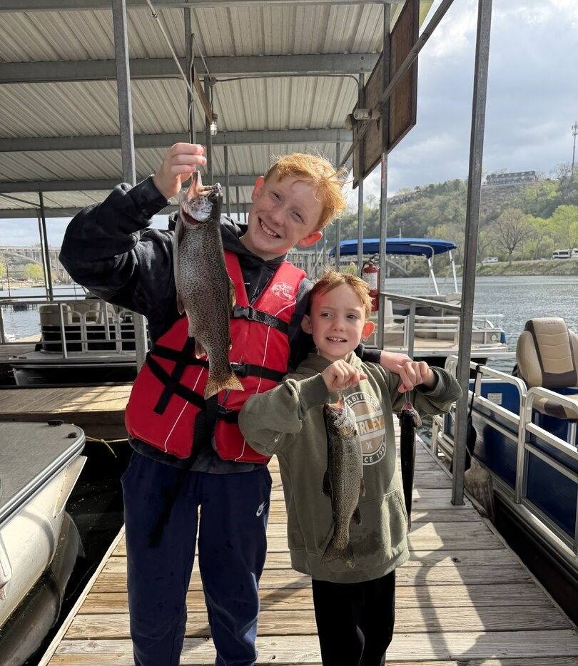 Two rainbow trout caught during fishing trip at marina dock