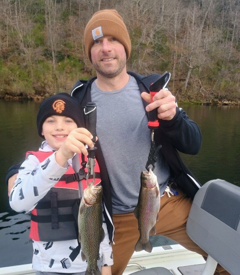 Two rainbow trout caught while fishing outdoors on a lake