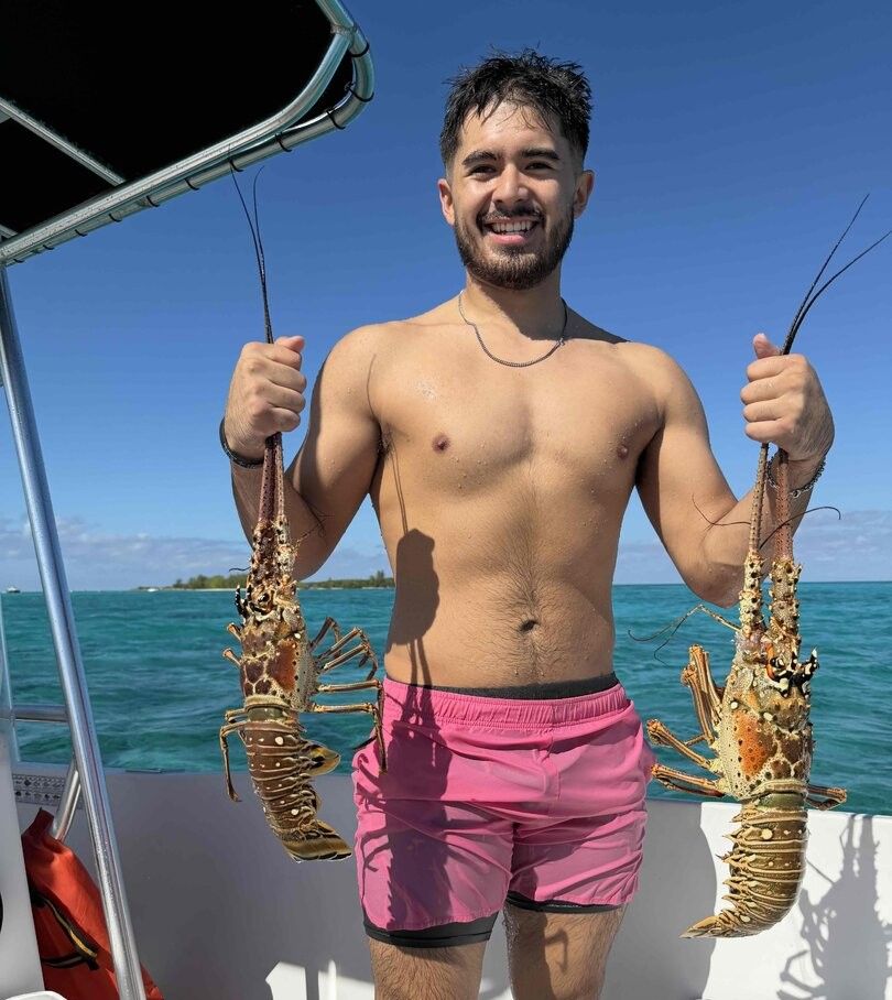 Two spotted gar caught while fishing on a boat in clear blue waters