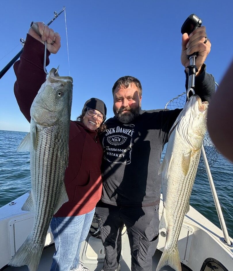 Two striped bass caught during fishing trip on boat
