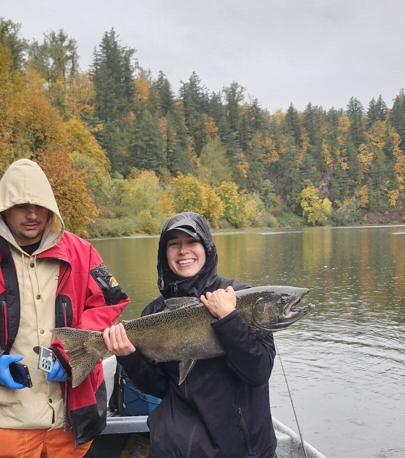 Two people fishing on an unknown body of water
