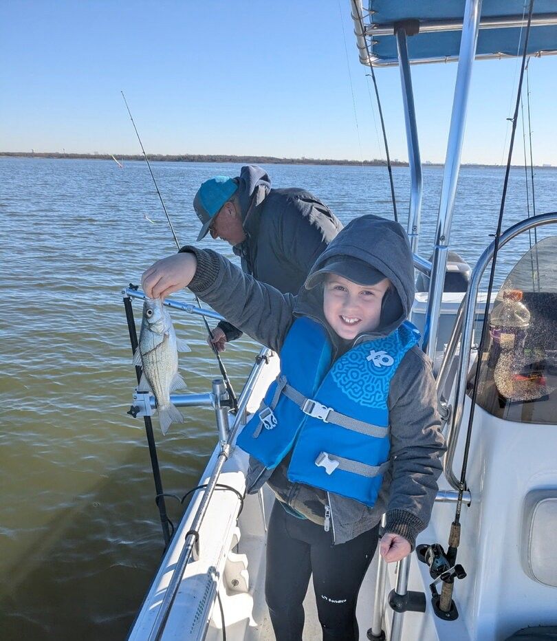 A person fishing in an unknown location
