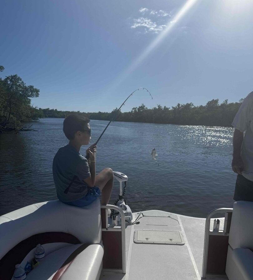 A person enjoying fishing at an unknown location