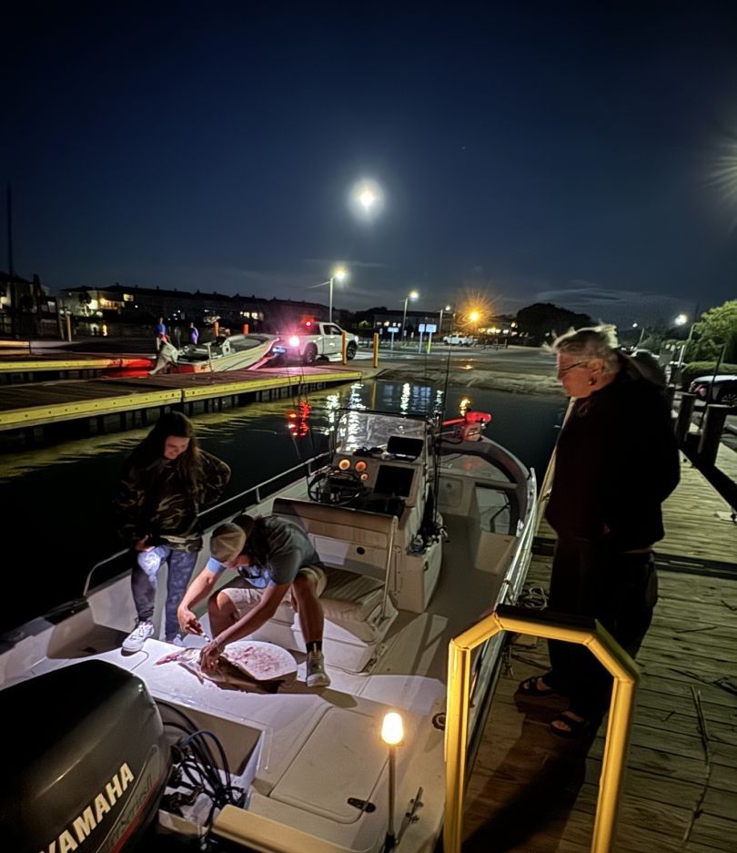 Two people fishing in an unknown location