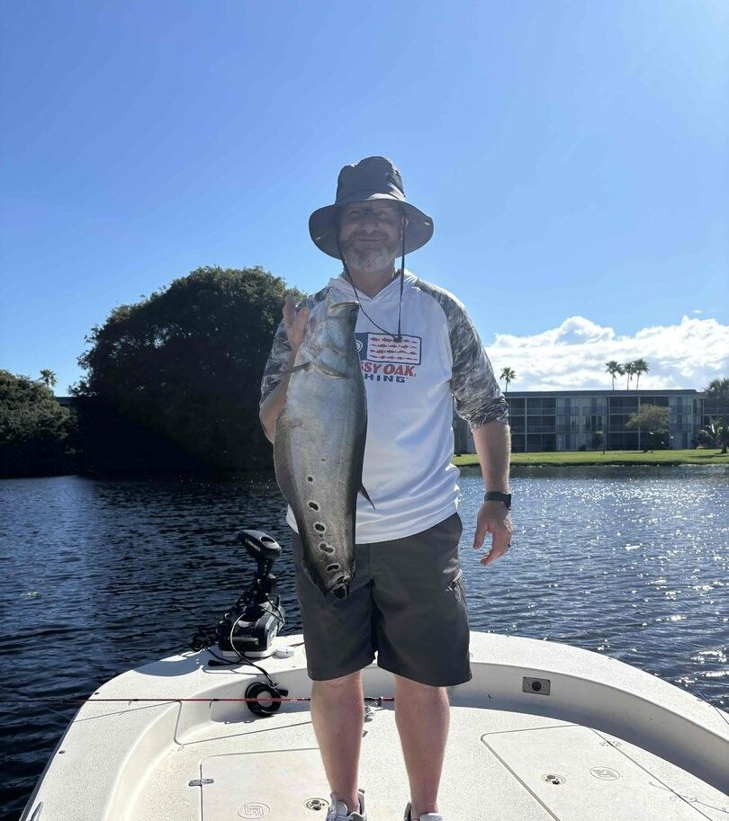 A person fishing in an unknown location