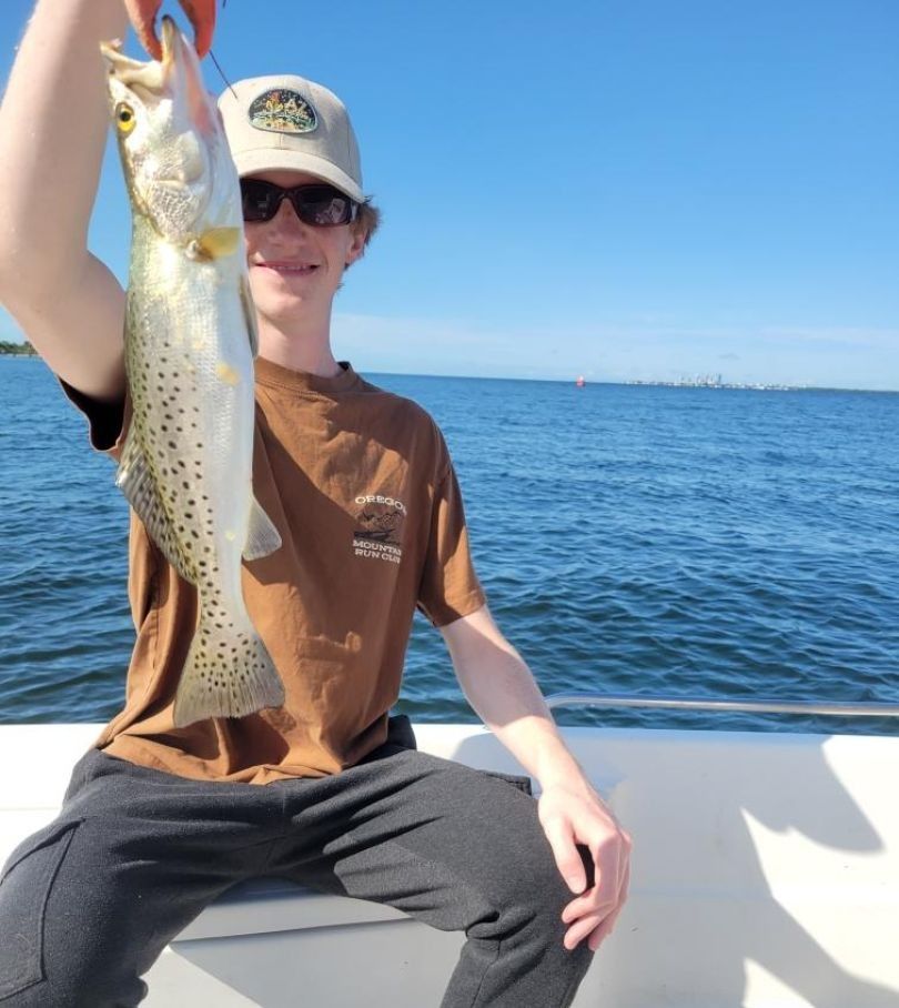 A person fishing at an unknown location