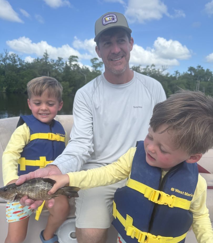 Three people fishing in an unknown location