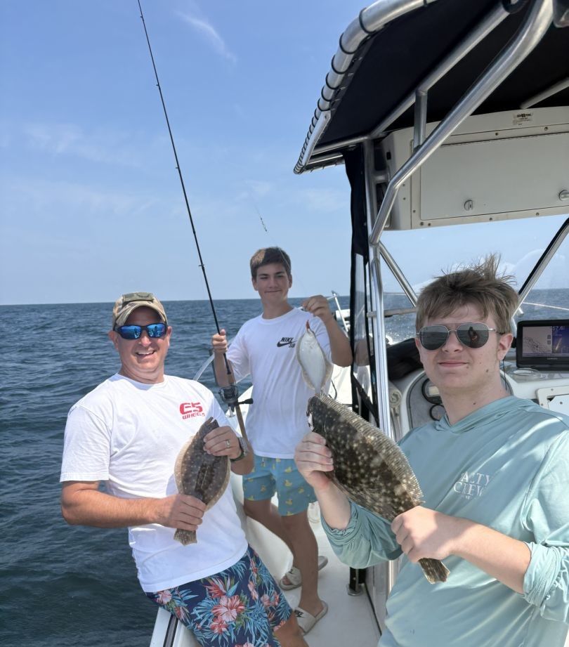 Three people fishing in a scenic location