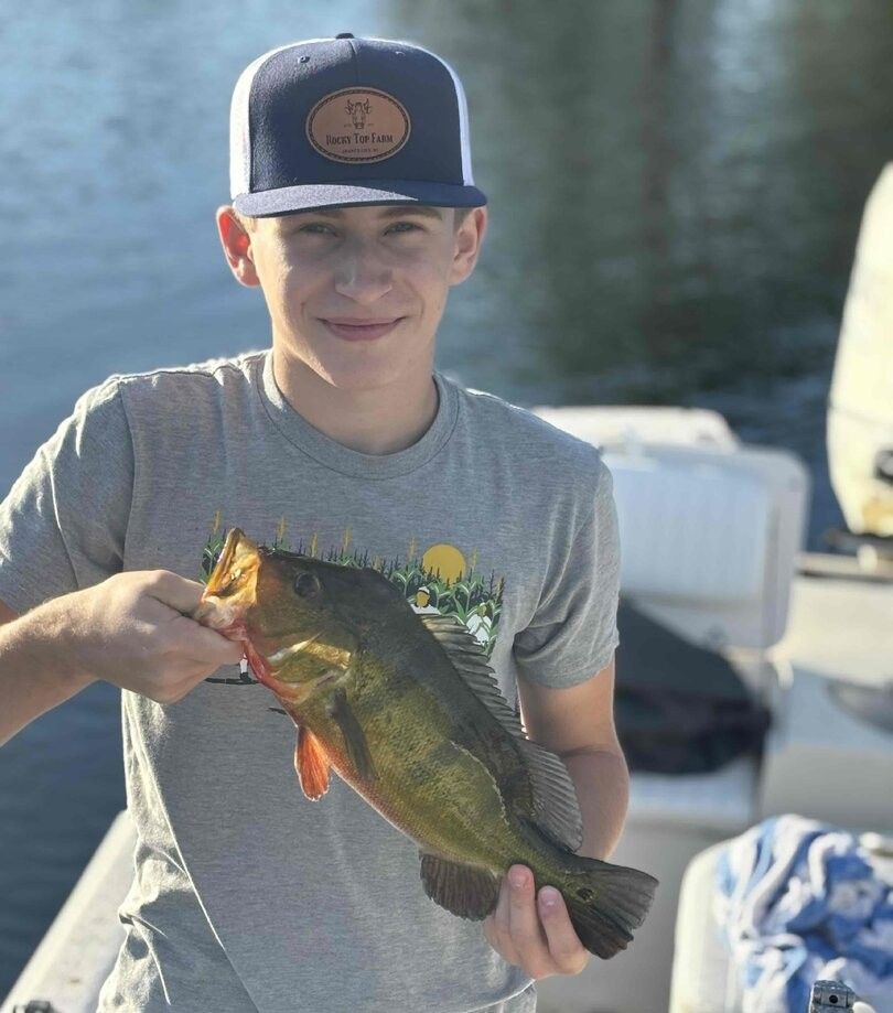 A person fishing in an unknown location