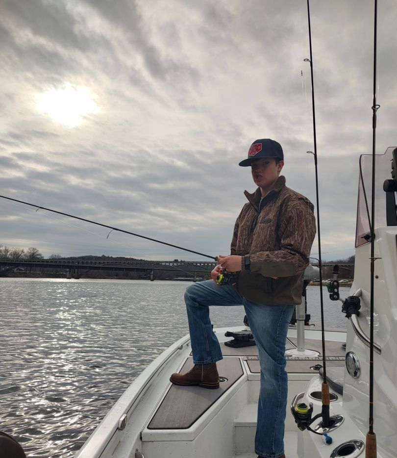 Angler fishing by the water's edge