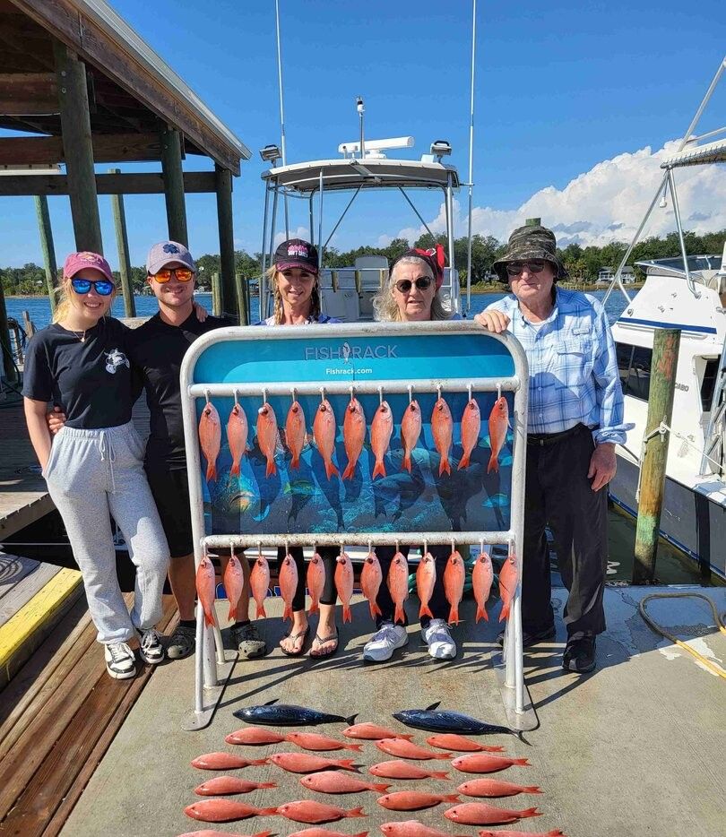 Five people fishing at a scenic location