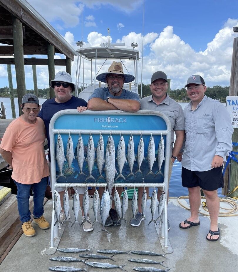 A group of 5 people enjoying a fishing trip