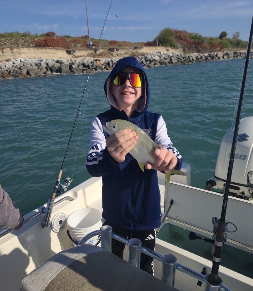 Angler catching fish during fishing excursion