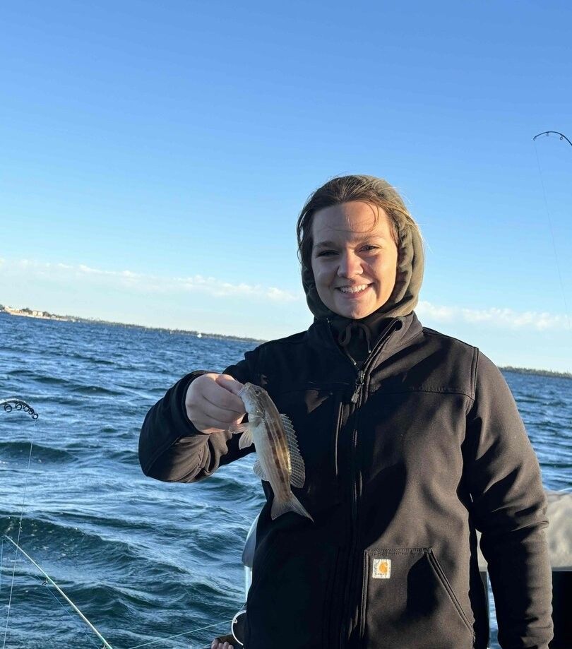 A person fishing in an unknown location