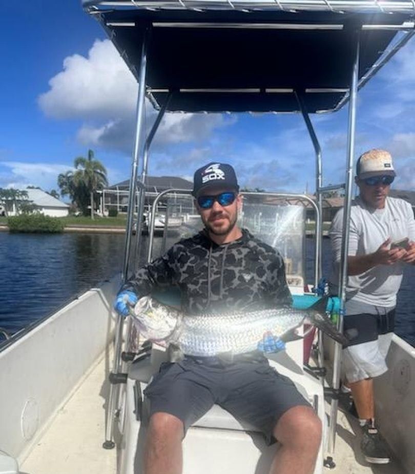 Two people fishing for a tarpon
