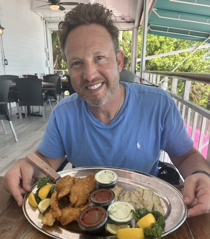 Fresh seafood platter with fried fish and shellfish served on outdoor restaurant deck