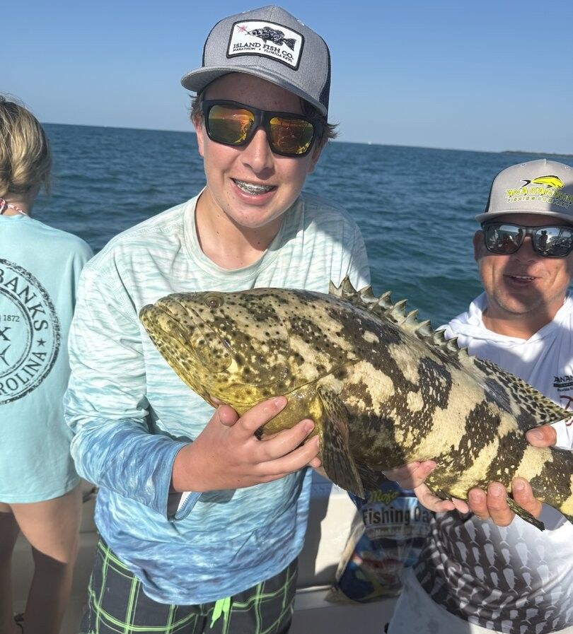Goliath grouper being held on fishing boat in ocean waters