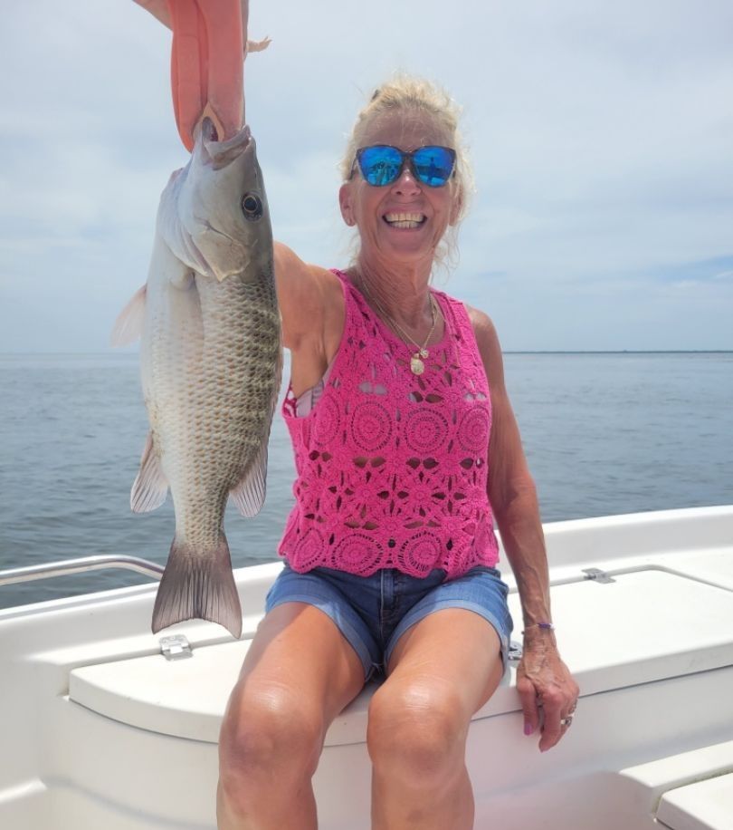 A grey snapper fish caught while fishing