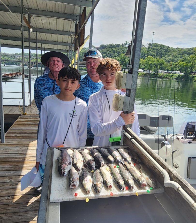 Group of 5 people fishing in unknown location