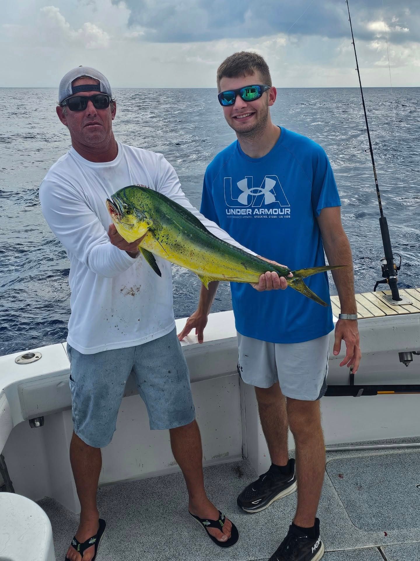 Mahi Mahi fish caught by two people while fishing