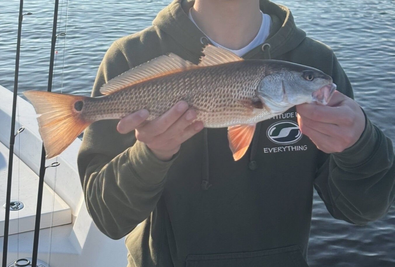 Redfish caught during fishing trip showing distinctive orange fins and scaled body