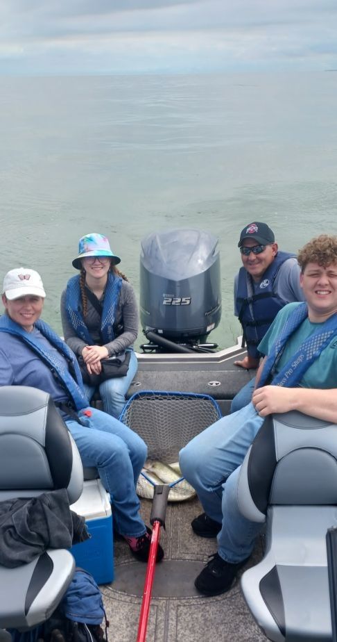 Four people fishing at a scenic outdoor location