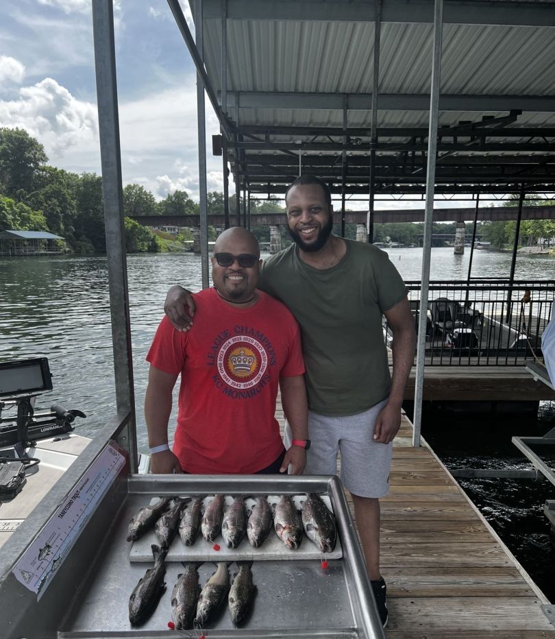 Two people fishing in a scenic location
