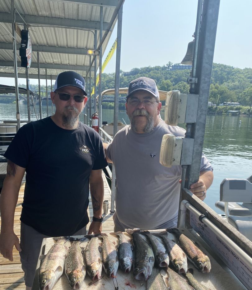 Two people fishing at a scenic location