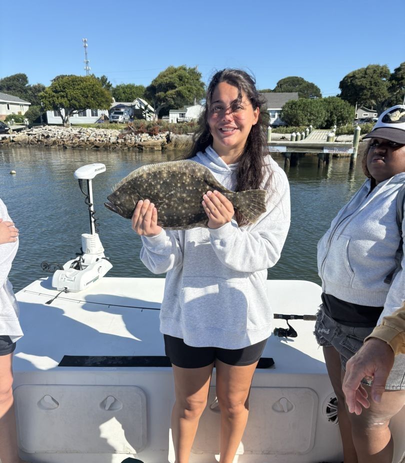 Angler reeling in a Southern Flounder on a fishing trip