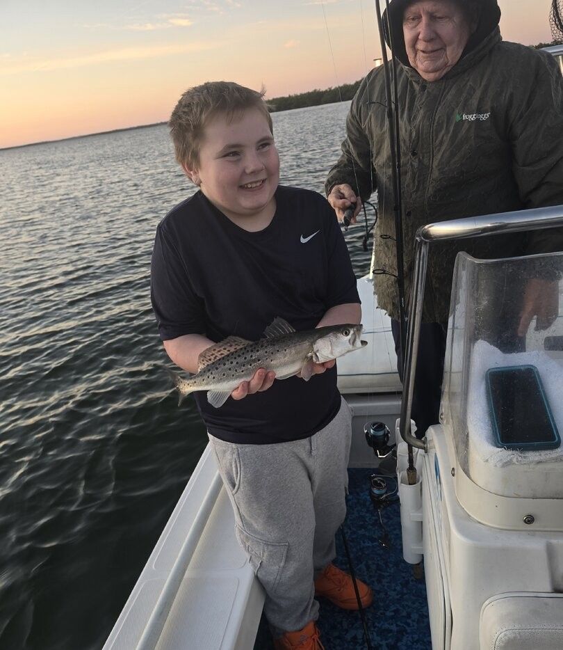 Speckled trout catch displayed on fishing boat during sunset