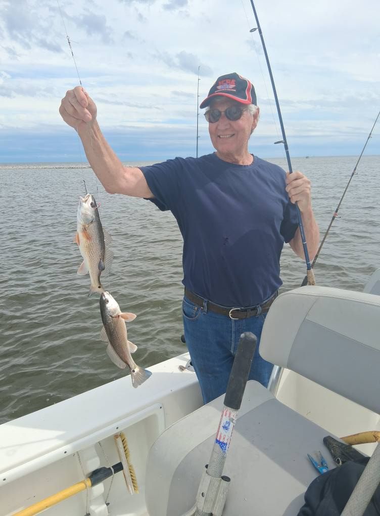 Angler with two fish in unknown location