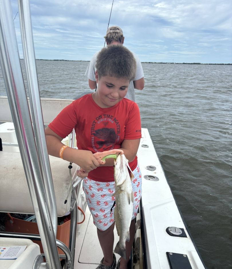 Angler with fishing rod, location unknown