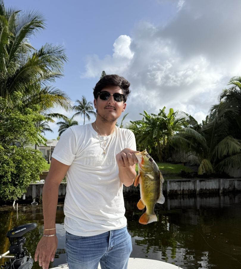 A person fishing in an unknown location