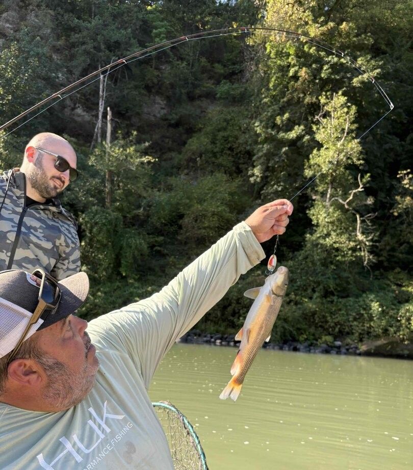 Two anglers fishing in unknown location