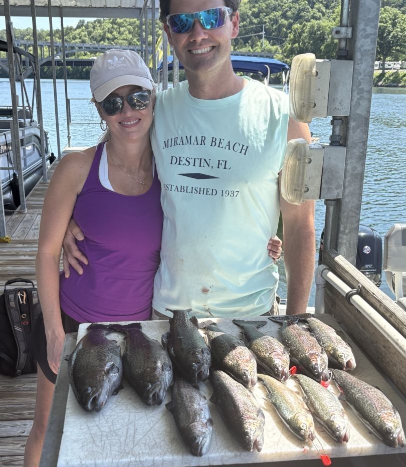 Two anglers fishing in unknown location with three fish