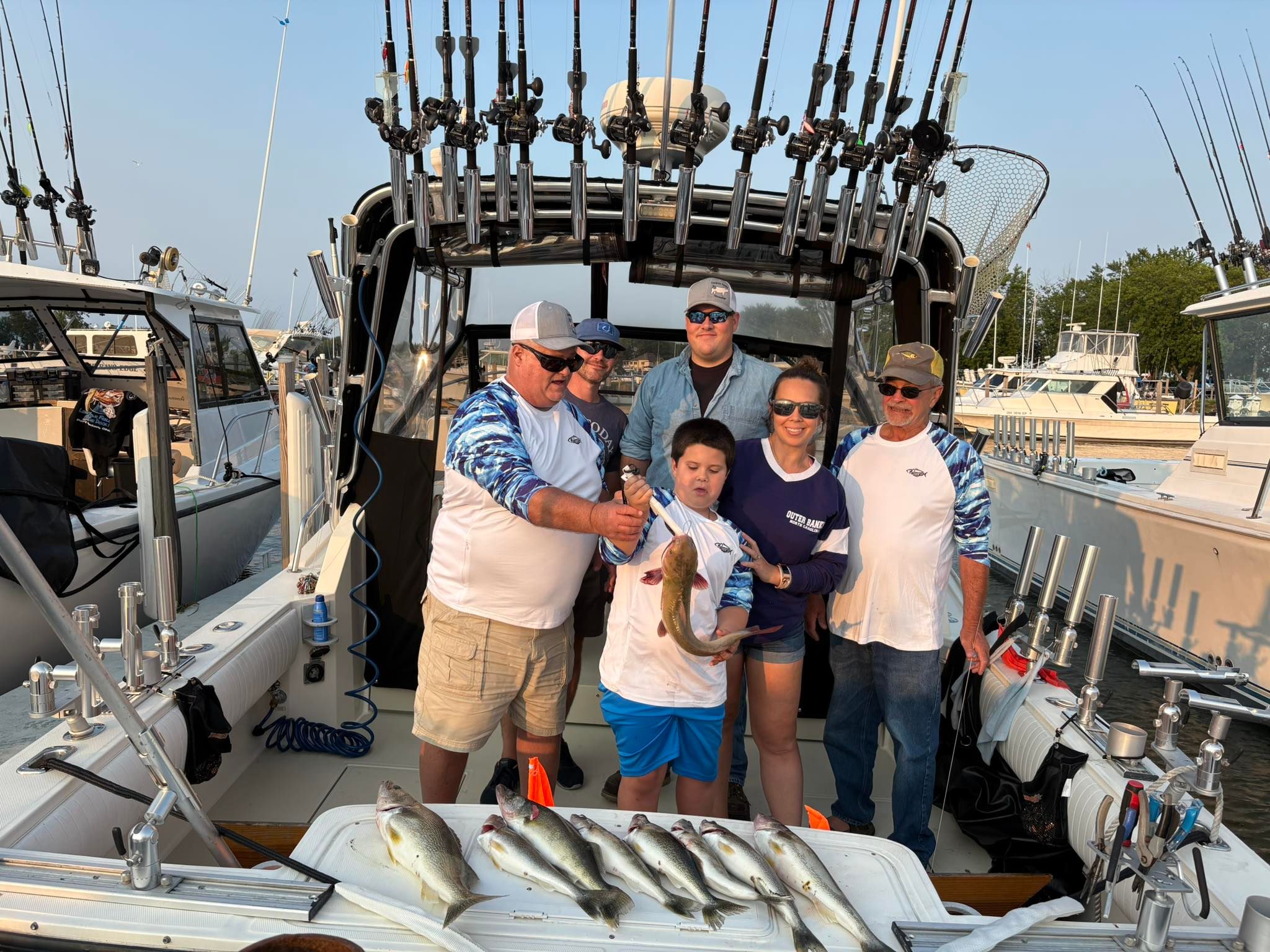 Anglers fishing on the water, catching two fish