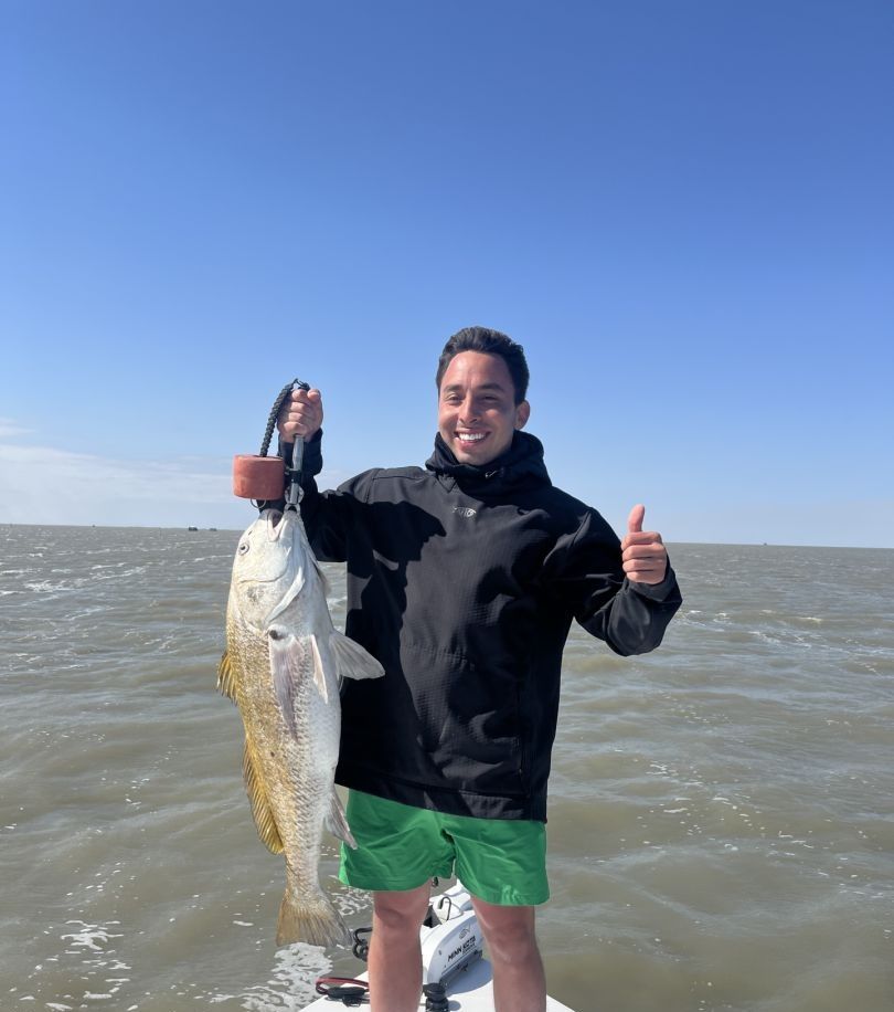 A person fishing at an unknown location