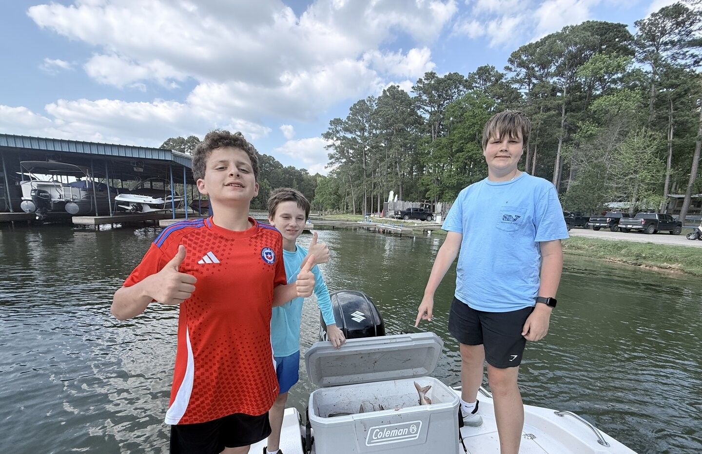 Fishing trip with cooler containing fresh caught fish at marina dock