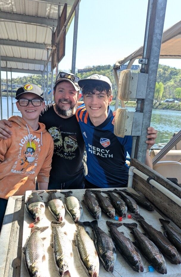 Successful fishing trip showing multiple caught fish displayed on cleaning station at covered dock