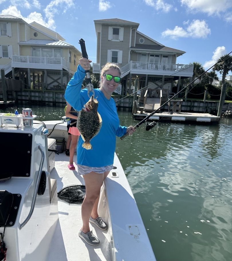Angler with summer flounder fish during fishing