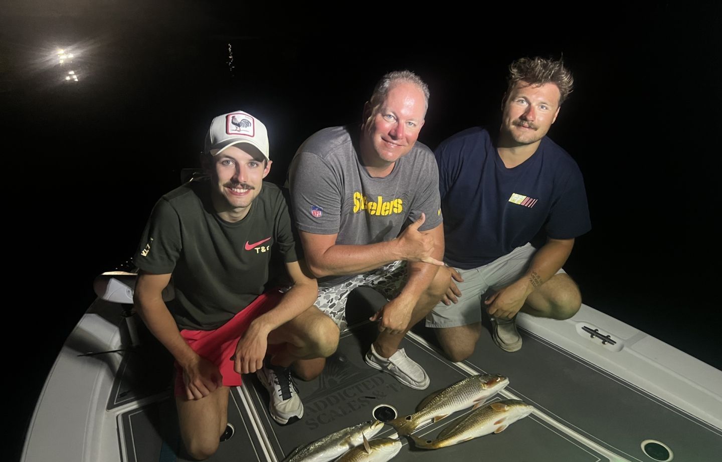 Three people fishing in an unknown location