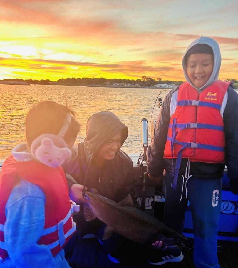 Two people fishing in an unknown location