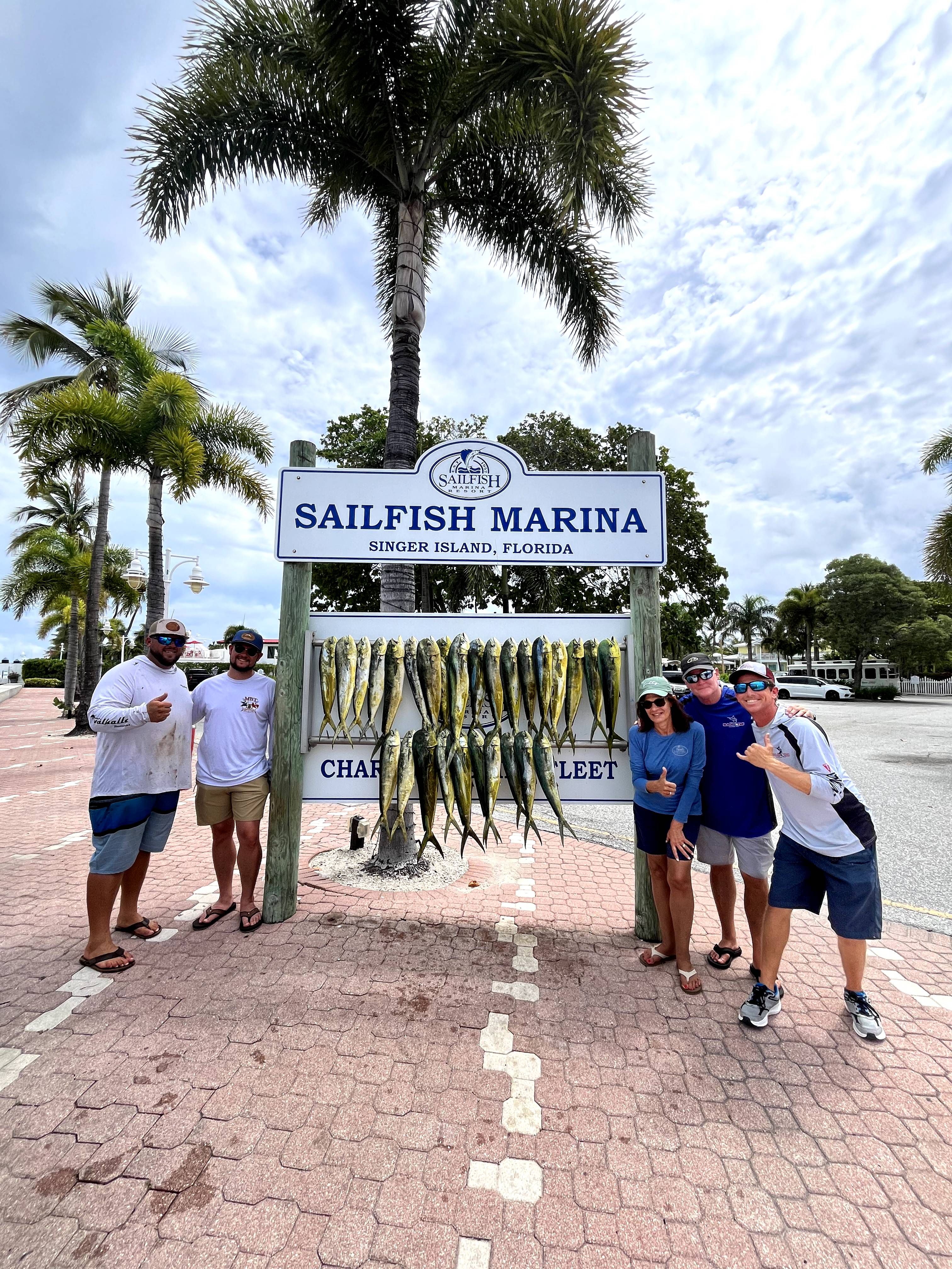 Group of anglers displaying their catch of mahi mahi at Sailfish Marina in Singer Island, Florida
