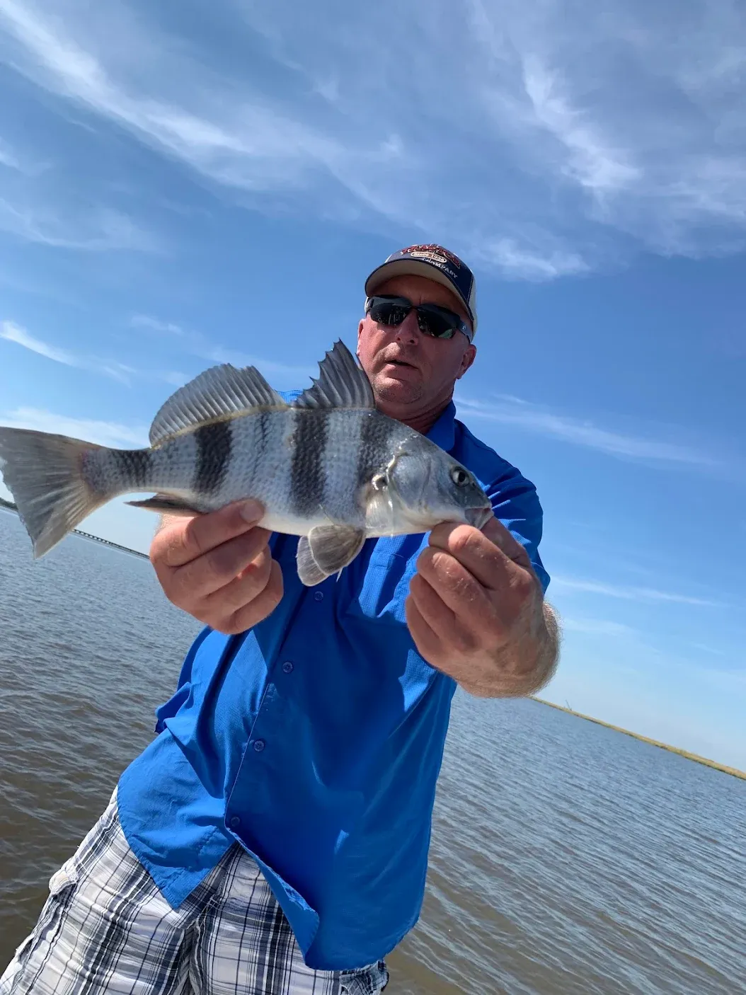 Angler with a black drum fish